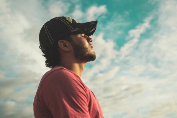 Man with cap breathing thru his nose